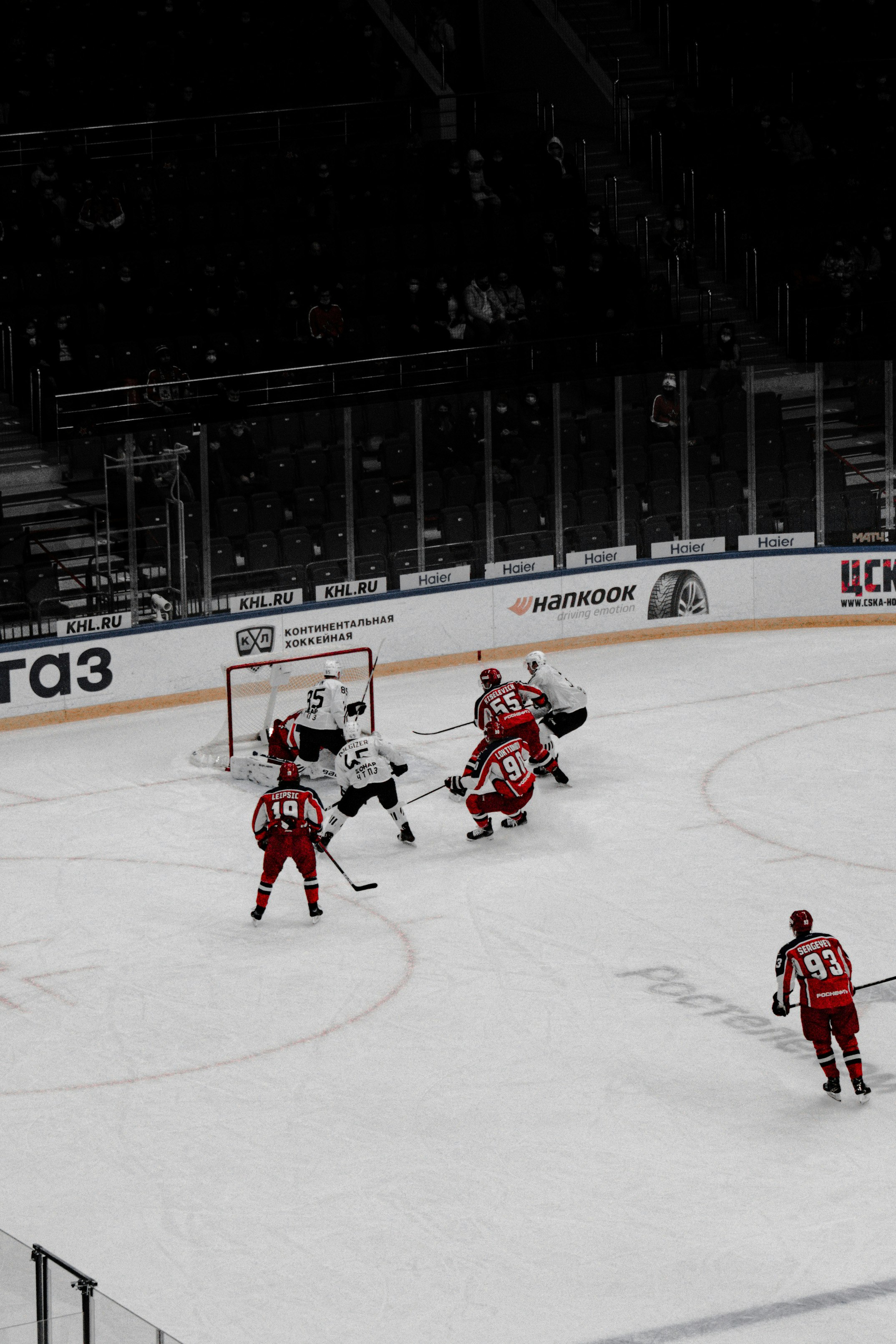 people playing ice hockey on ice field during daytime